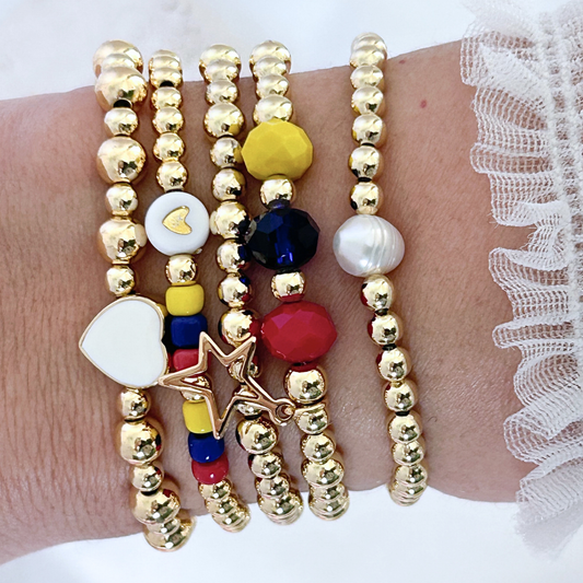 Multicolored beaded bracelets on a wrist with a white lace background