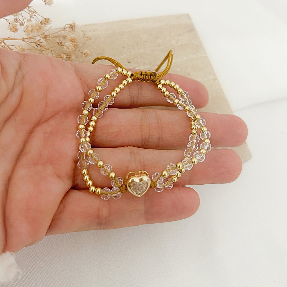 Crystal beaded bracelet with copper heart charm, adjustable cord