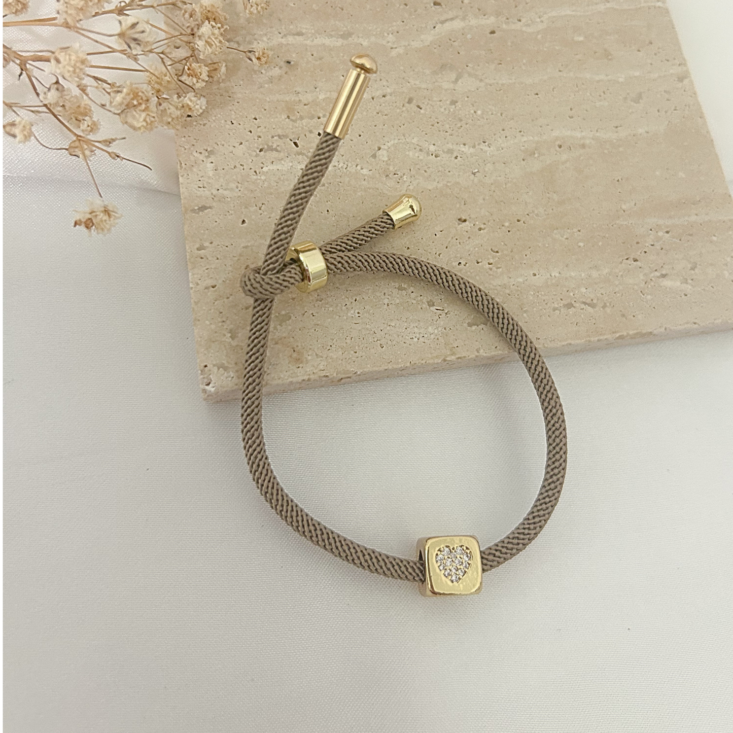 Beige mesh cord bracelet with pavé heart cube charm