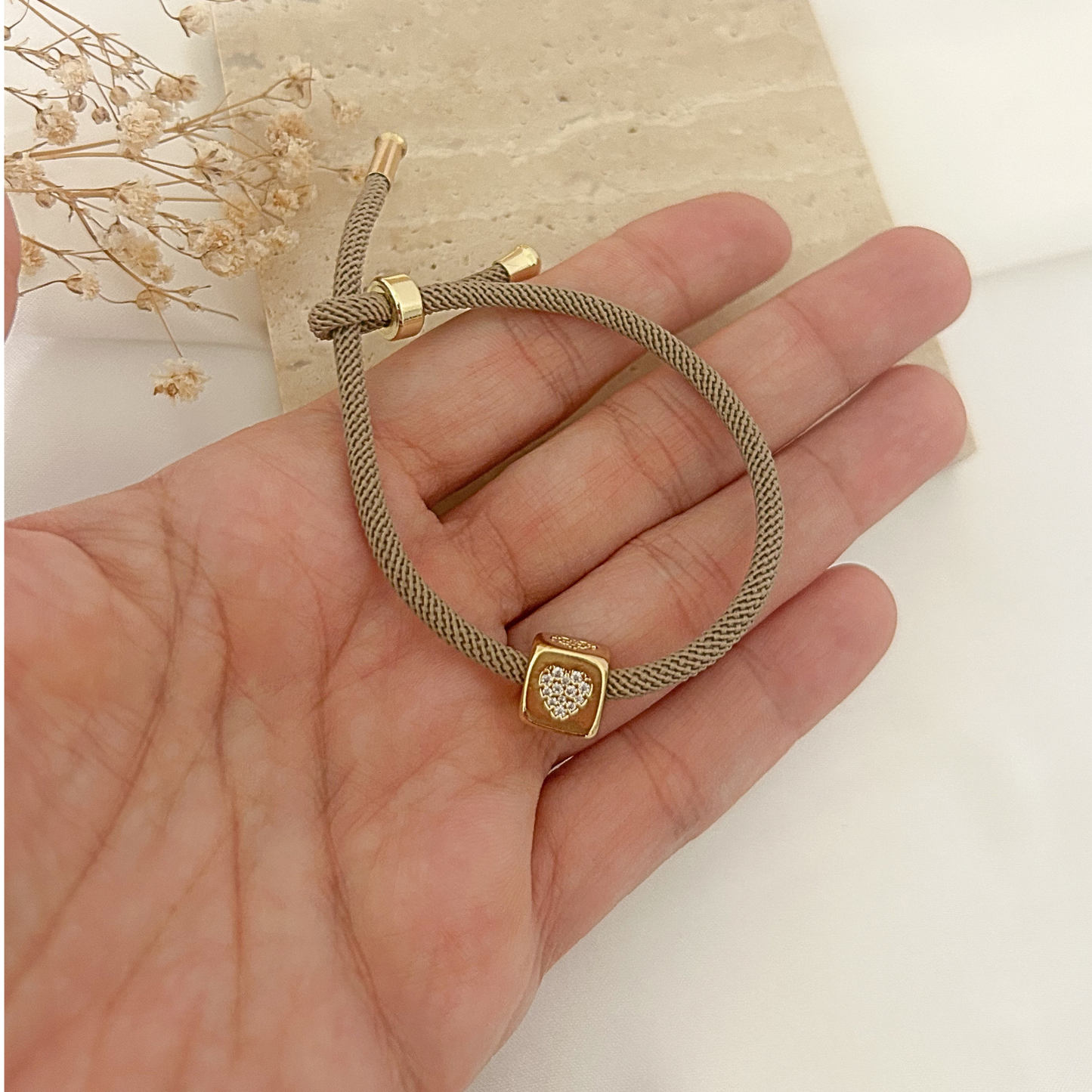 Beige mesh cord bracelet with pavé heart cube charm