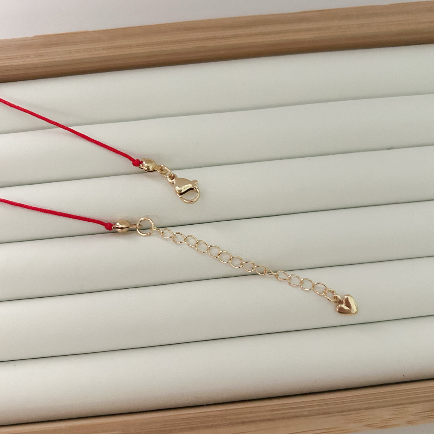 red cord necklace gold clasp extender chain heart detail