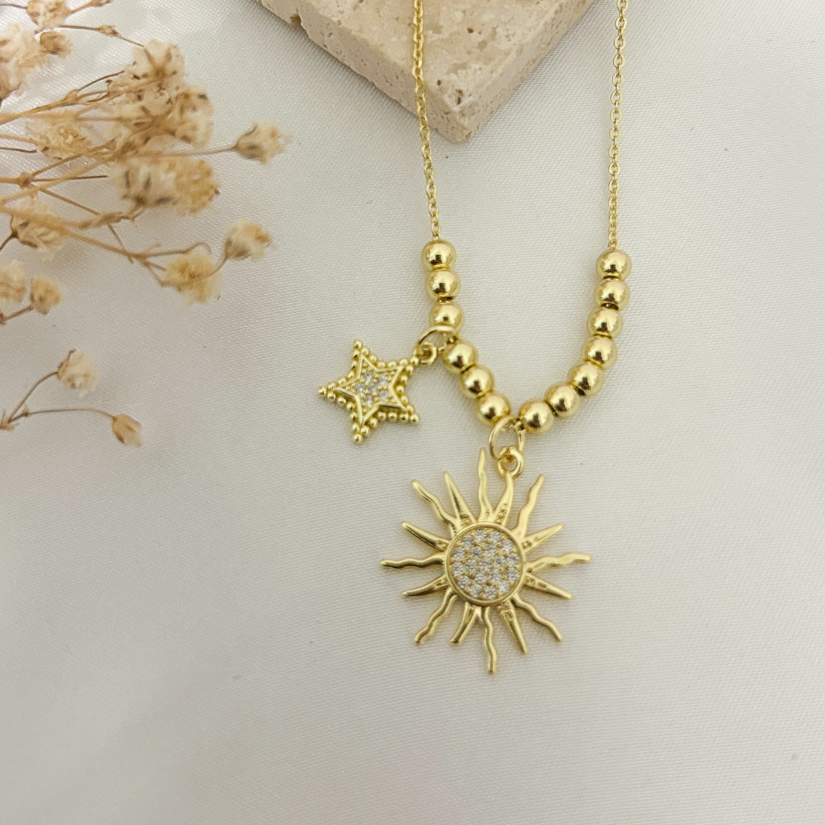 Sunburst necklace with pavé star charm on gold chain