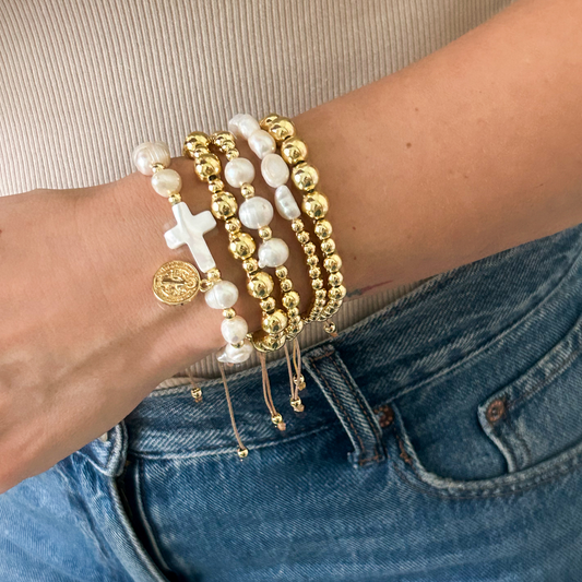 Saint Benedict pearl cross bracelet set with gold medallion worn on wrist