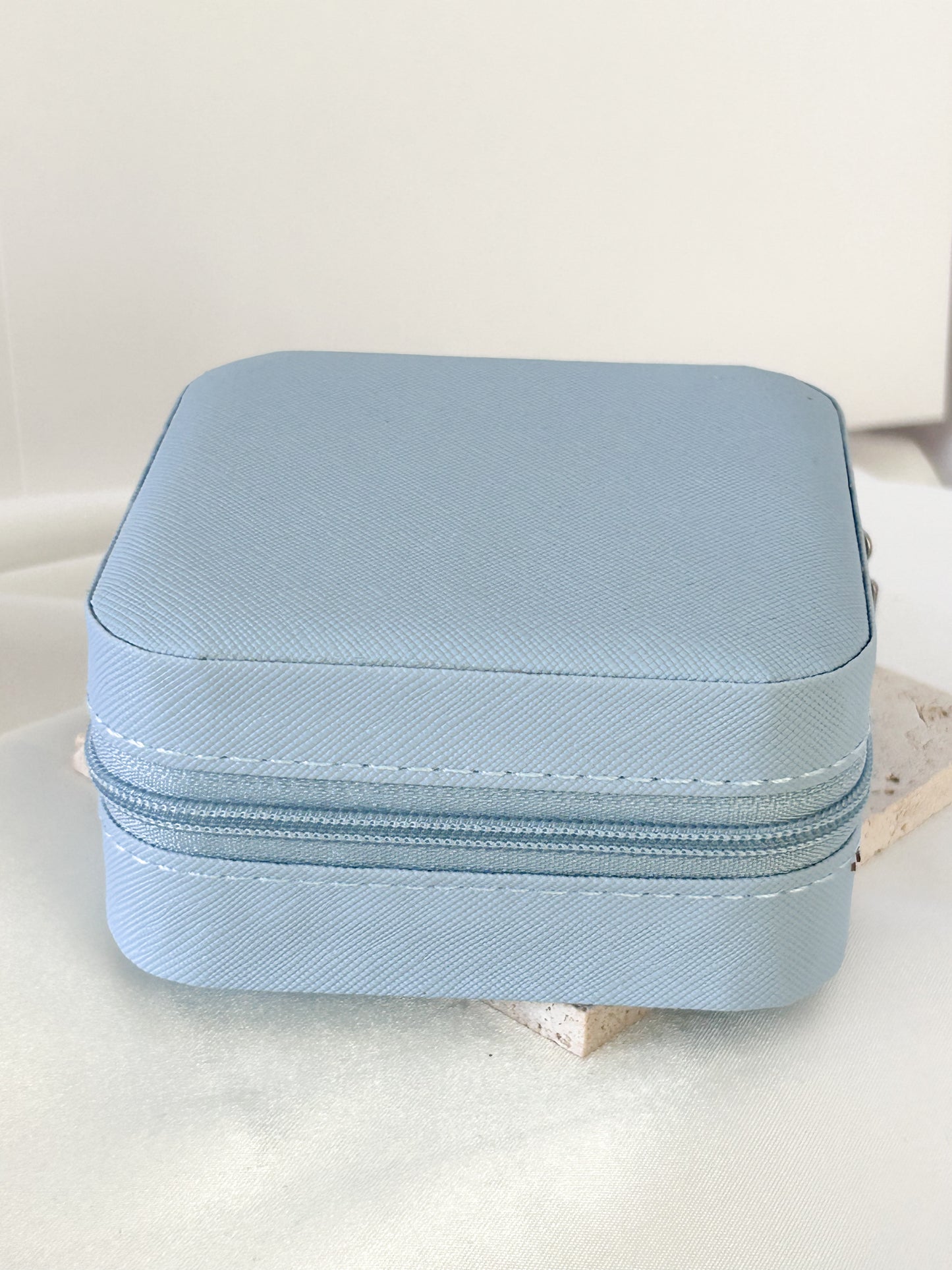 Light blue jewelry case on a white surface