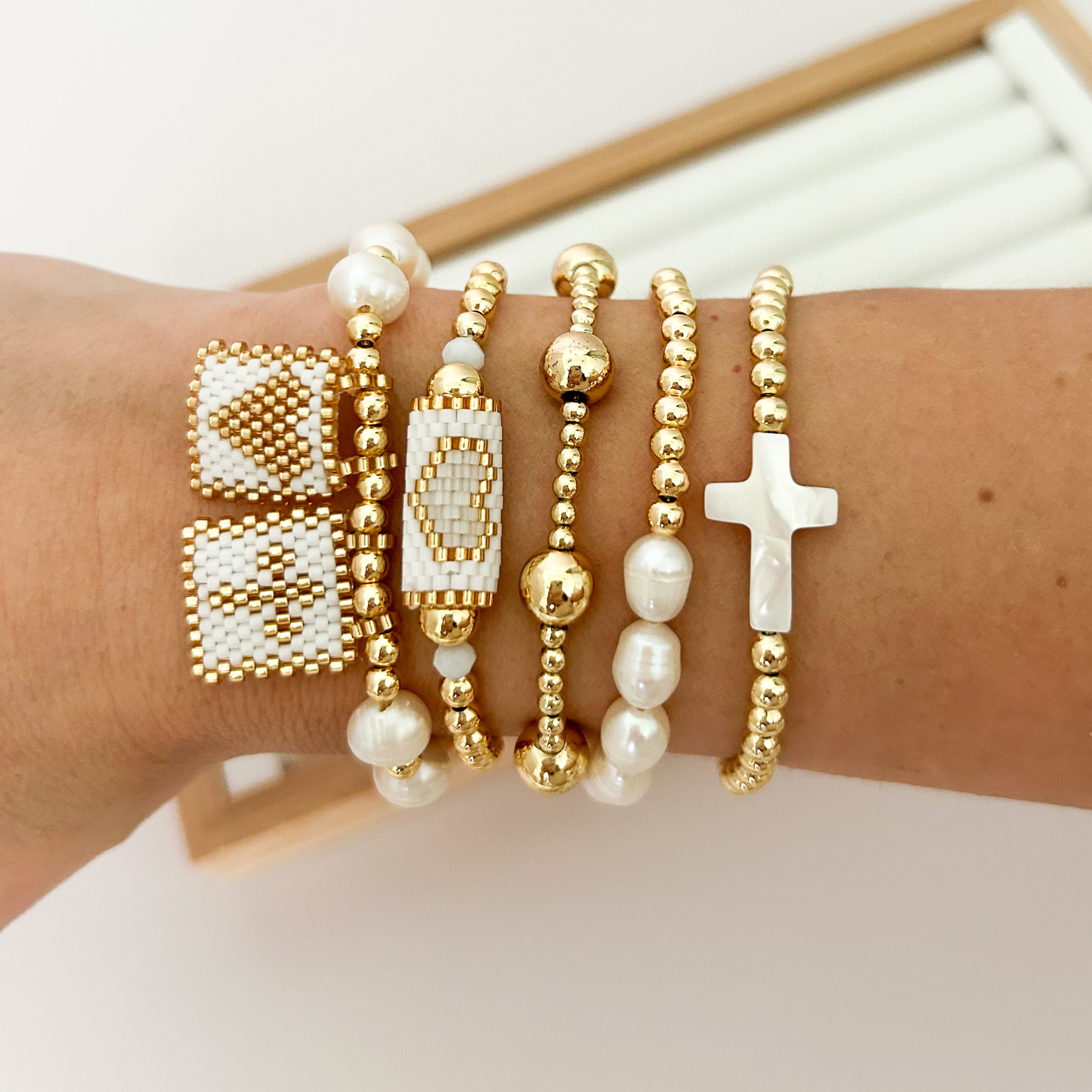 White gold miyuki woven bracelet stack with baroque pearls styled on wrist