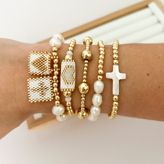 White gold miyuki woven bracelet stack with baroque pearls styled on wrist