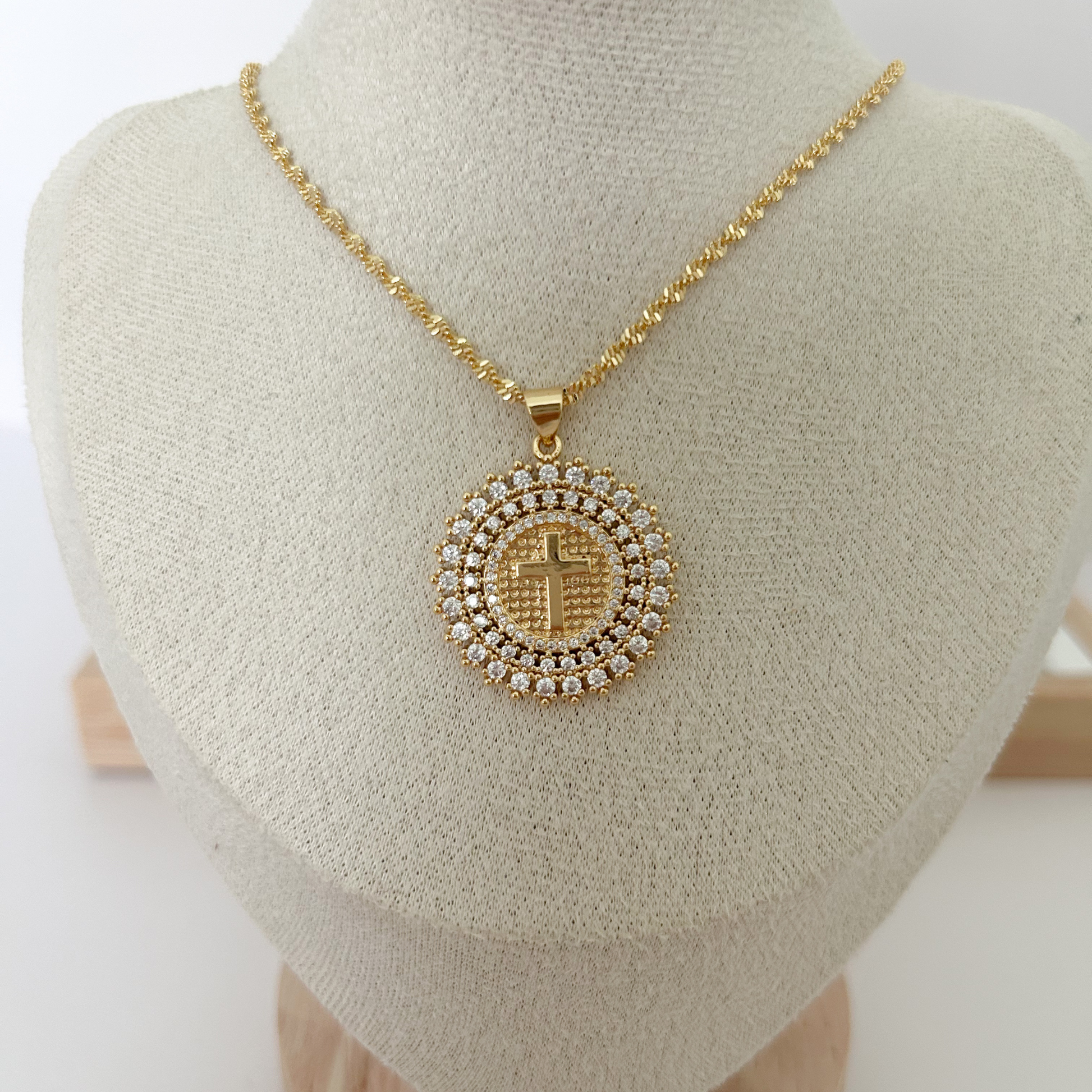 Gold cross pendant necklace with rhinestone medallion design for everyday wear.
