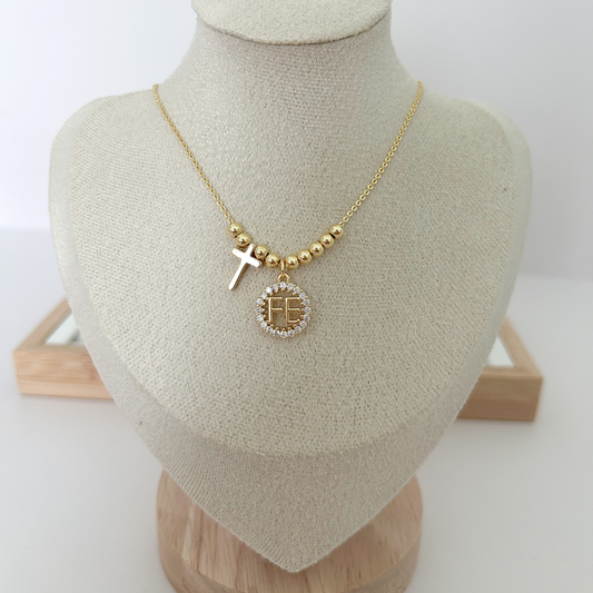 Gold necklace with a pendant on a mannequin bust against a white background