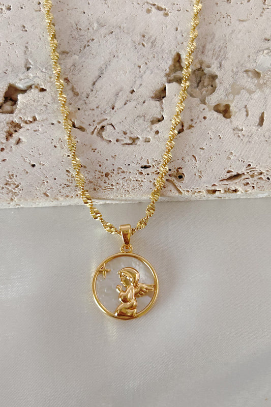 Gold necklace with a pendant featuring a cherub on a textured surface