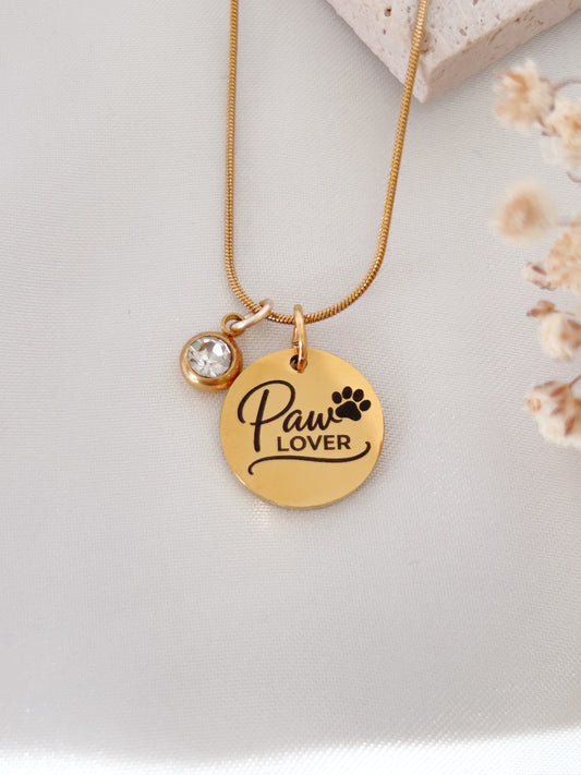 Gold necklace with 'Paw Lover' pendant on a light background