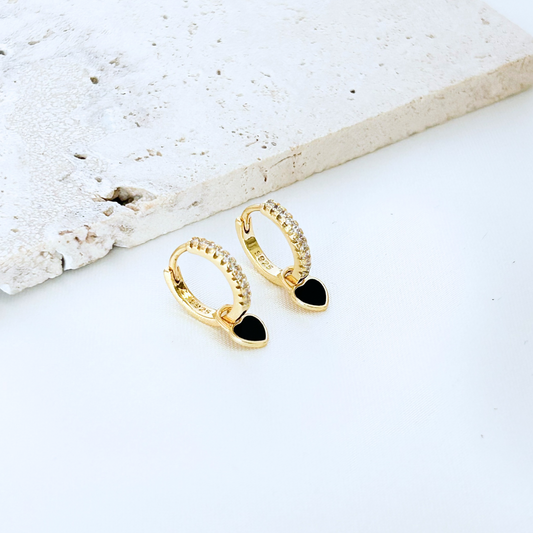 gold huggie earrings with black heart charm minimalist modern style