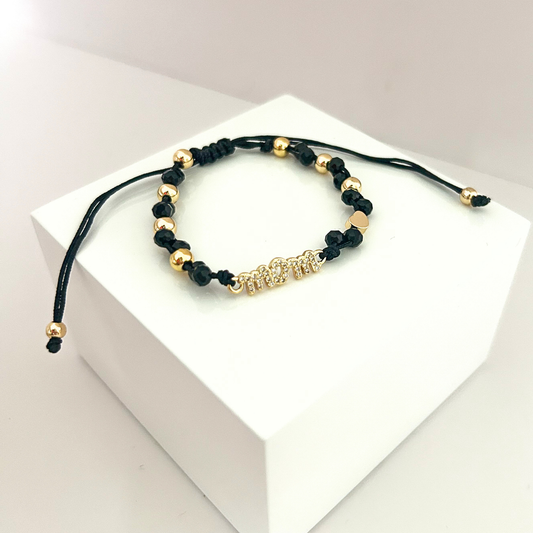 Adjustable black beaded bracelet featuring a sparkling MOM charm, gold-tone accents, and a minimalist elegant design.