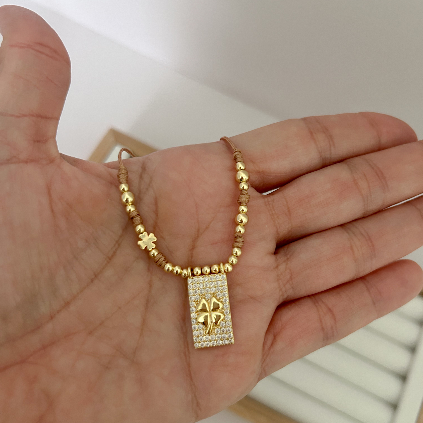 gold necklace with clover pendant, chic layered necklace women, waterproof gold jewelry, stylish everyday accessory, feminine necklace aesthetic