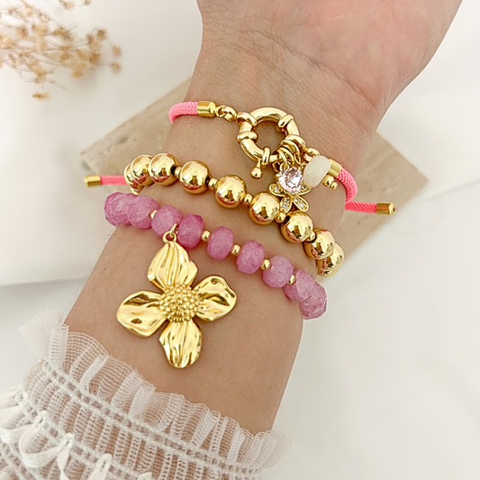 Blush Bloom bracelet set worn on wrist, pink cord and magenta crystal styles