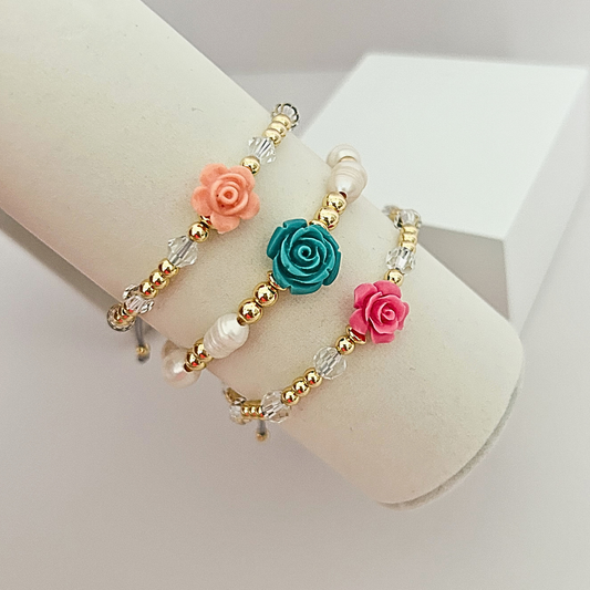 Adjustable handmade flower bracelets available in turquoise, pink, and peach variations with gold-tone beads, crystal accents, and freshwater pearls.