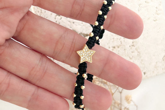 gold star charm bracelet close up minimal everyday jewelry