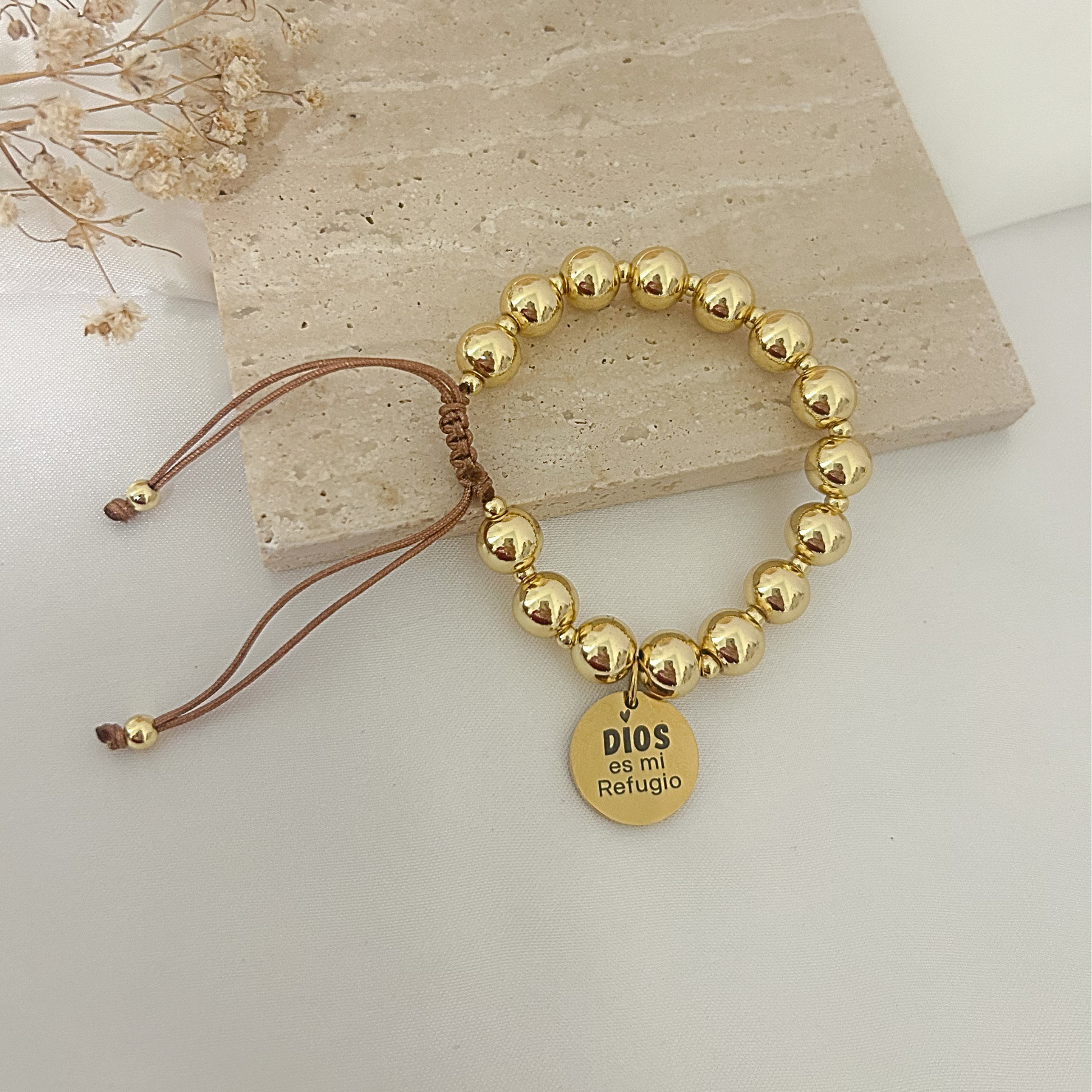Gold bead bracelet with “Dios Es Mi Refugio” engraved faith charm