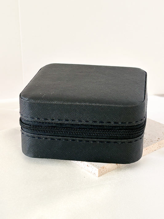 Black jewelry box with a zipper on a light background