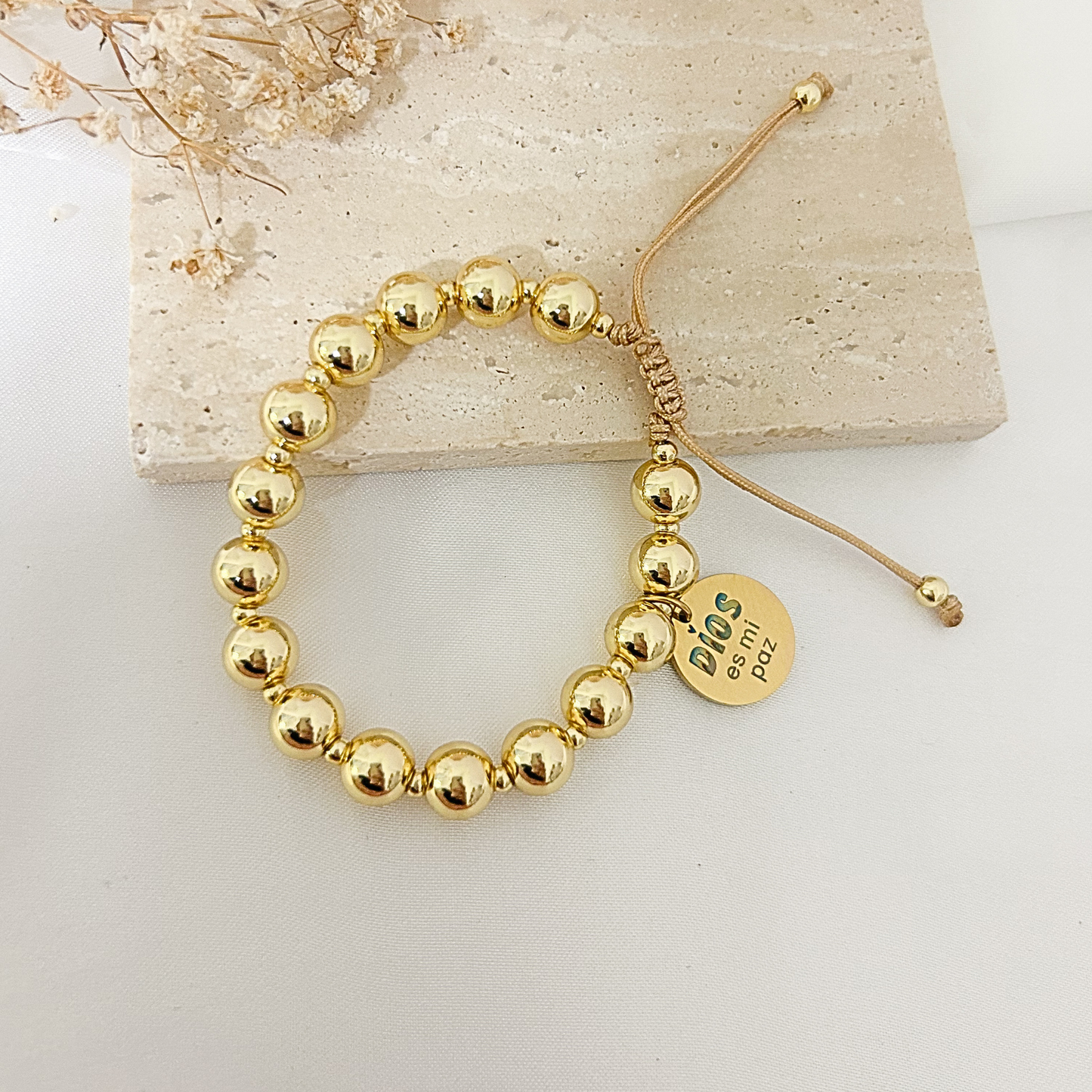 Gold bead bracelet with engraved peace charm