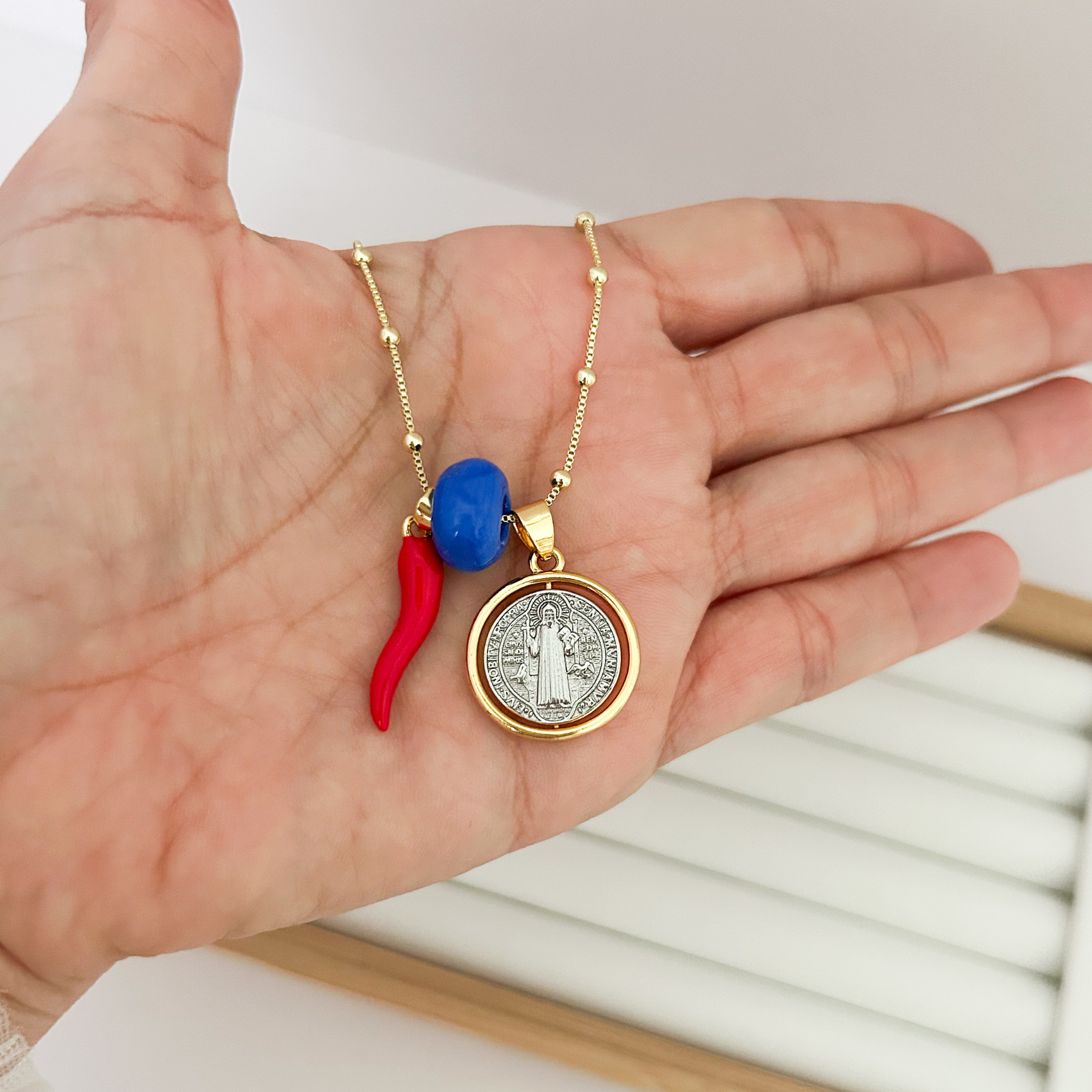 gold San Benito chain with red and blue charms, waterproof religious necklace, minimalist saint necklace, stylish everyday jewelry, charm necklace aesthetic