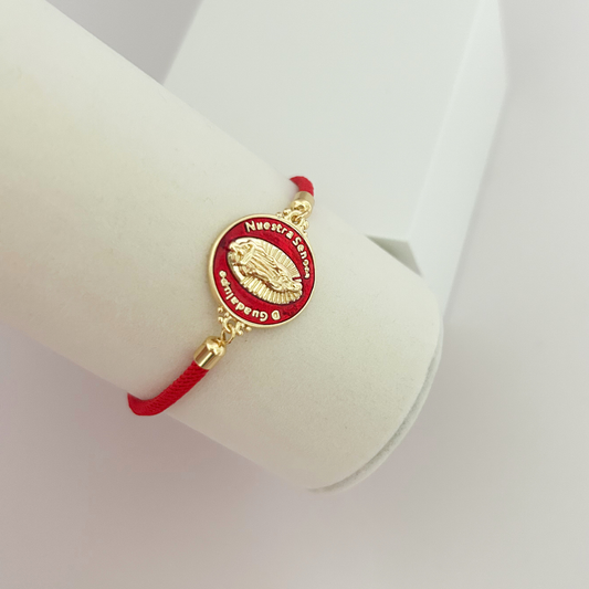 Our Lady of Guadalupe bracelet with red cord and gold-tone religious medallion.