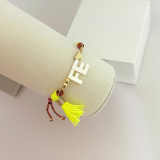 Handmade faith bracelet featuring white FE letters, heart charm and neon yellow tassel.
