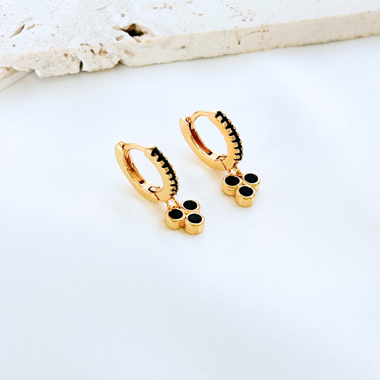 gold huggie earrings with black dot detail modern contrast design