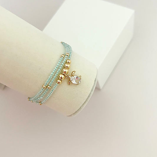 Elegant handcrafted bracelet with soft aqua beads and a crystal sea turtle pendant, inspired by the beauty of the ocean.