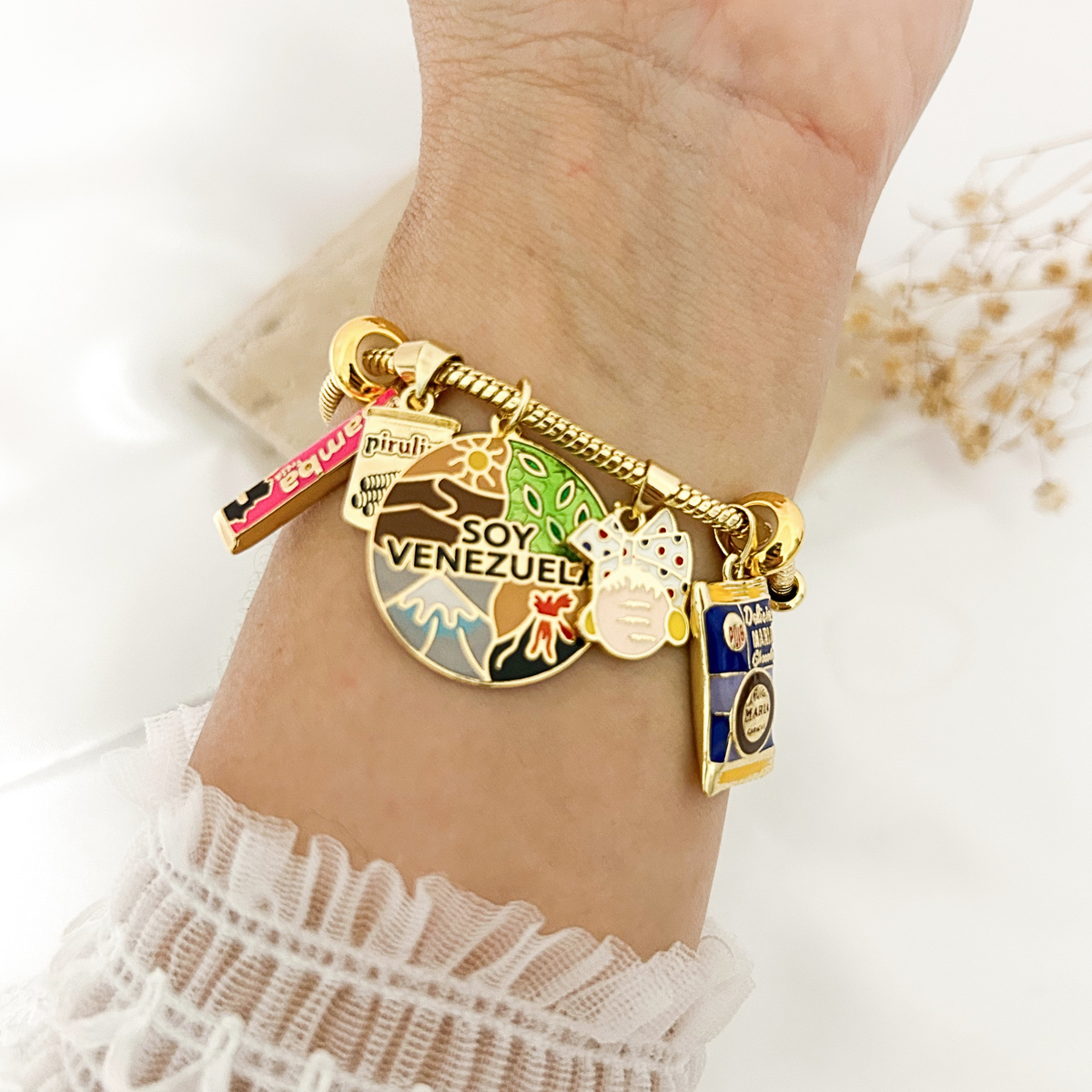 Hand holding Soy Venezuela charm bracelet to show detail