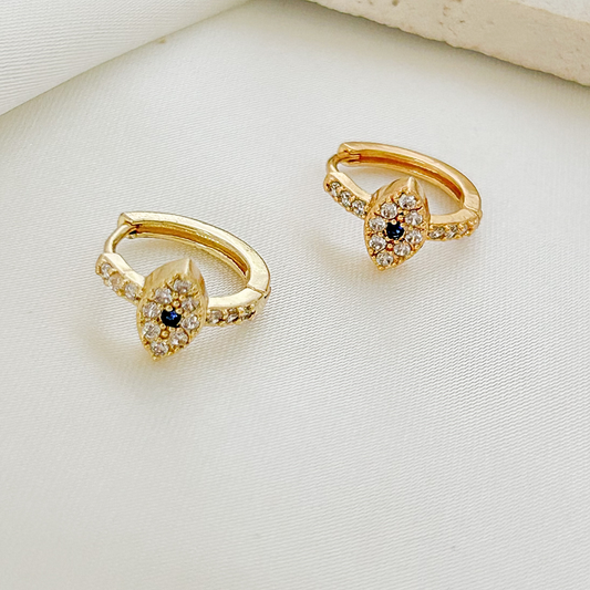 Gold evil eye hoop earrings with sparkling clear crystals and a deep blue center stone.