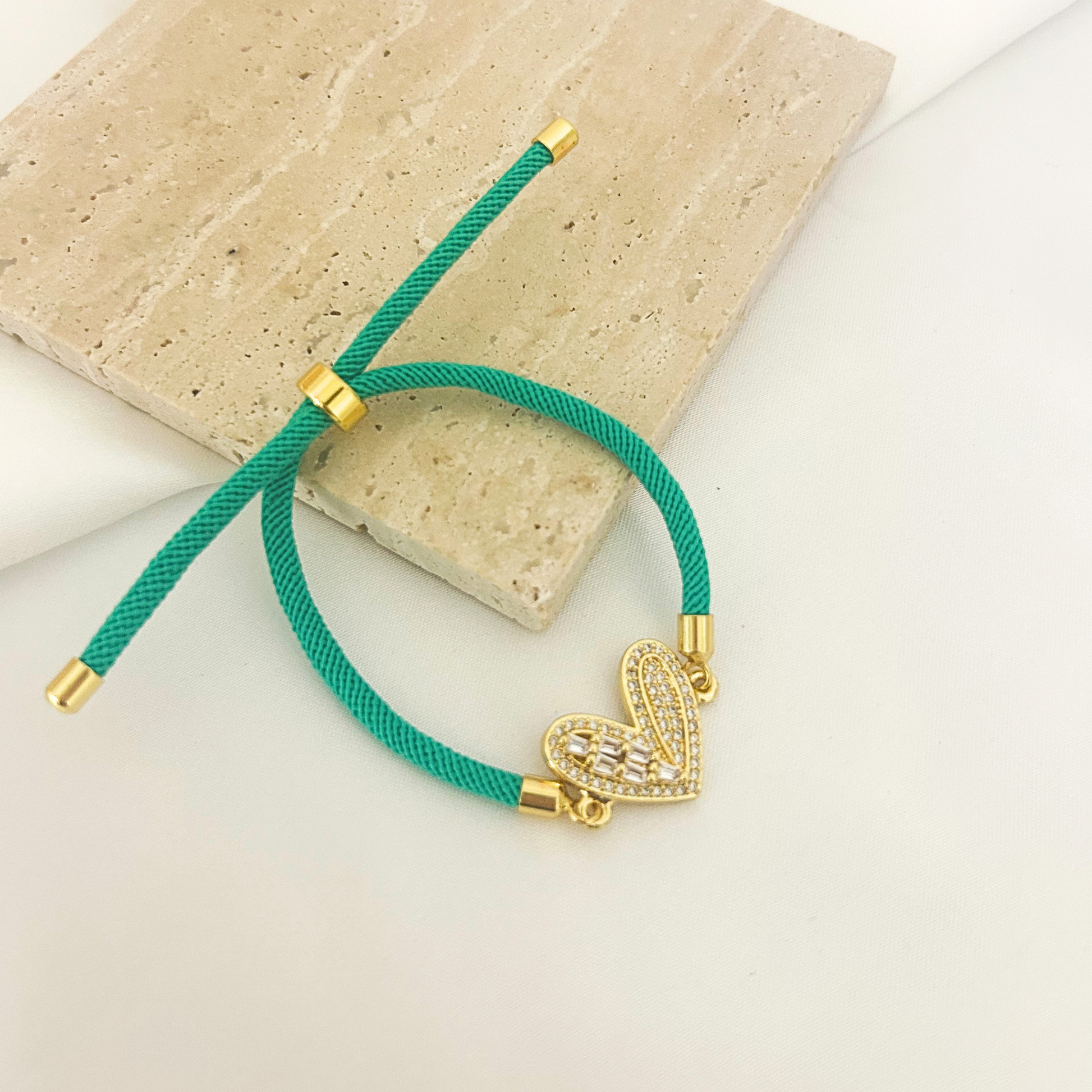 Teal cord bracelet with pavé heart charm