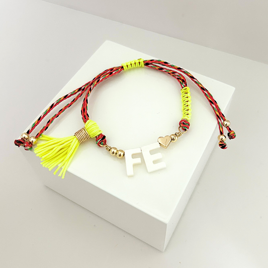 Colorful adjustable bracelet with FE lettering, tassel charm and gold-tone accents.